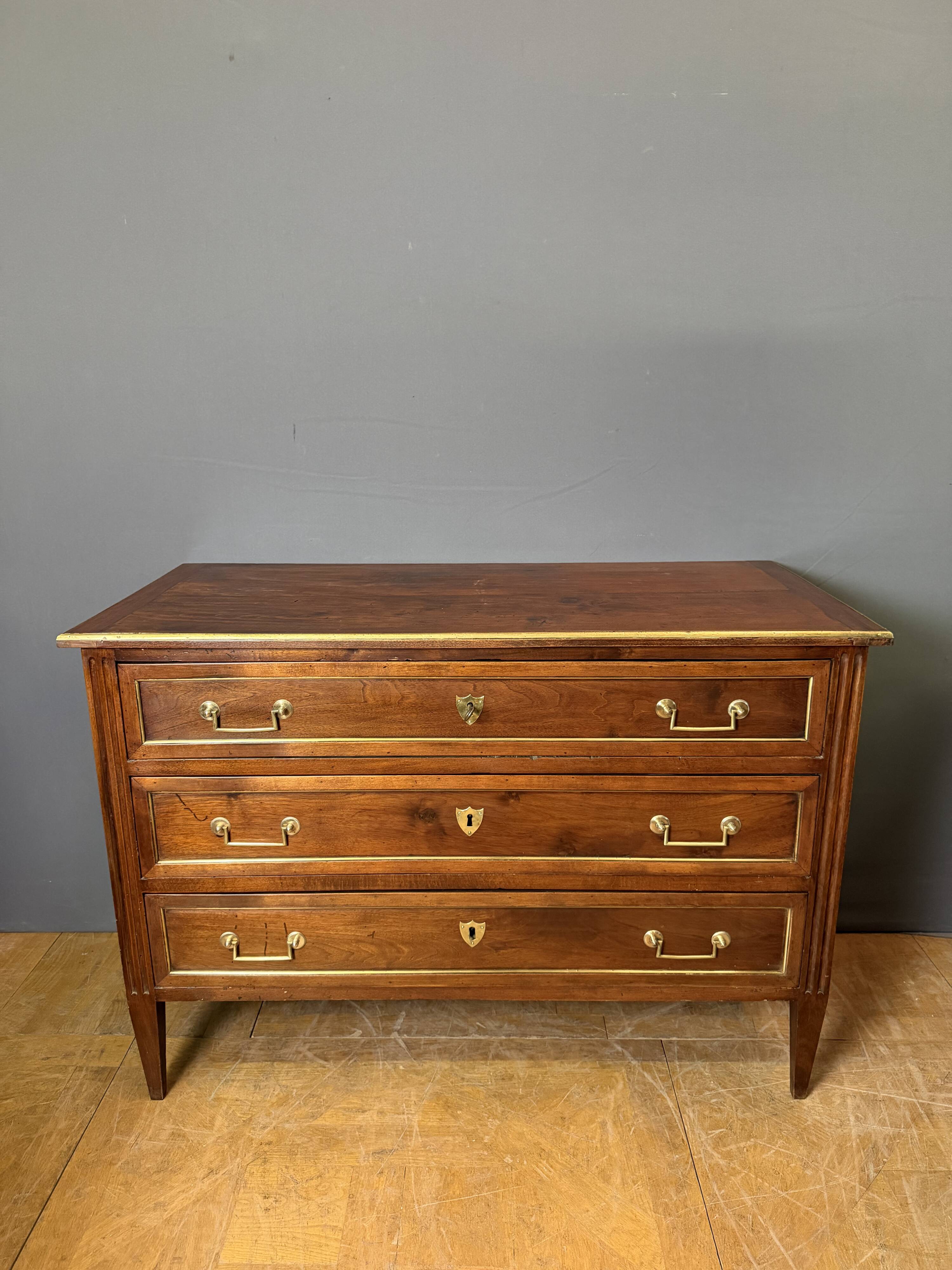 Louis XVI commode in walnut, beech, and brass.