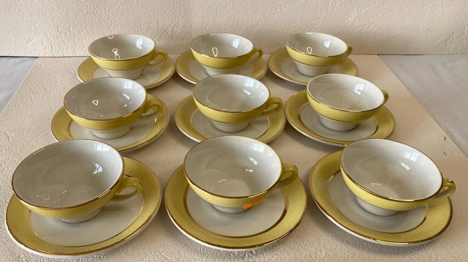 Yellow and white cups and saucers with gold trim Moulin des loups