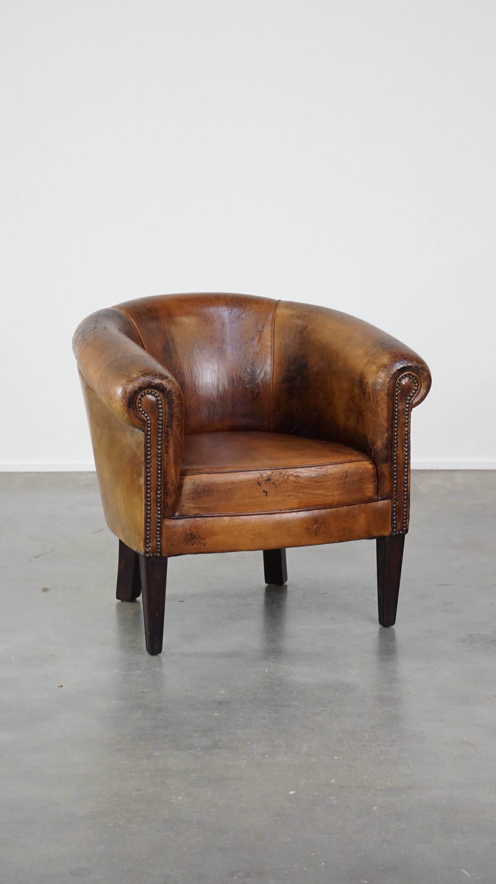 Sturdy, stately and subtle vintage sheepskin club chair