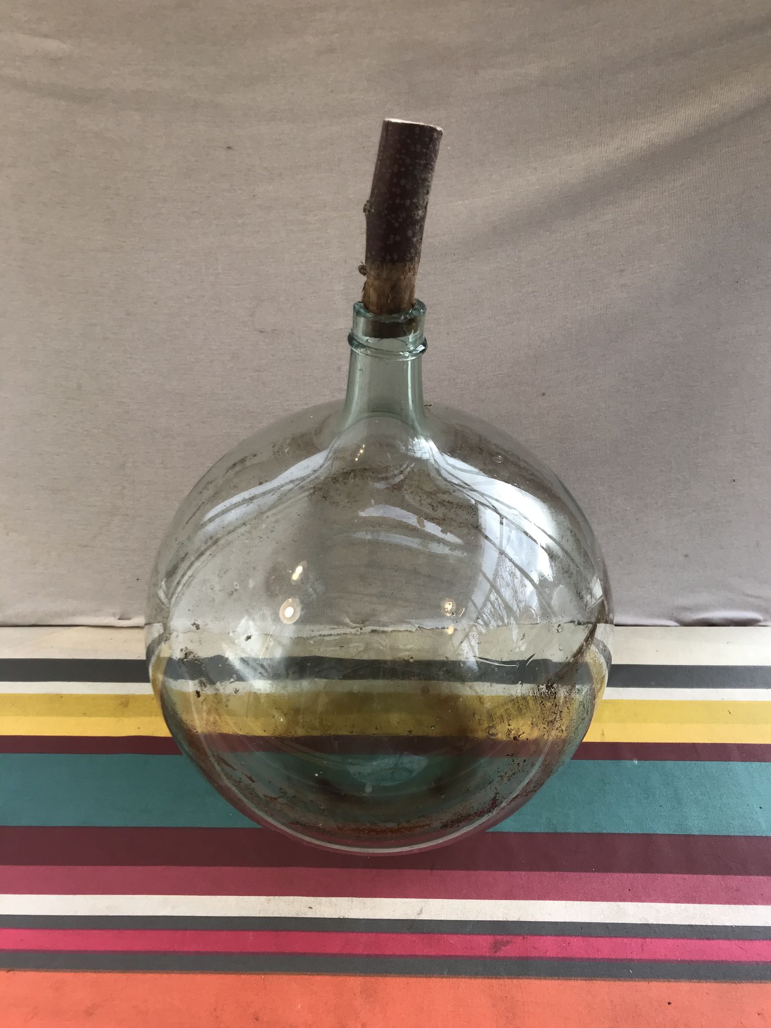 Former green glass demijohn