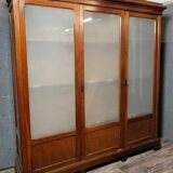 Large pine bookcase with three doors, fitted with frosted glass.