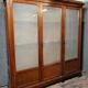 Large pine bookcase with three doors, fitted with frosted glass.