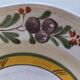 Two earthenware plates with fruits, pears and plums.