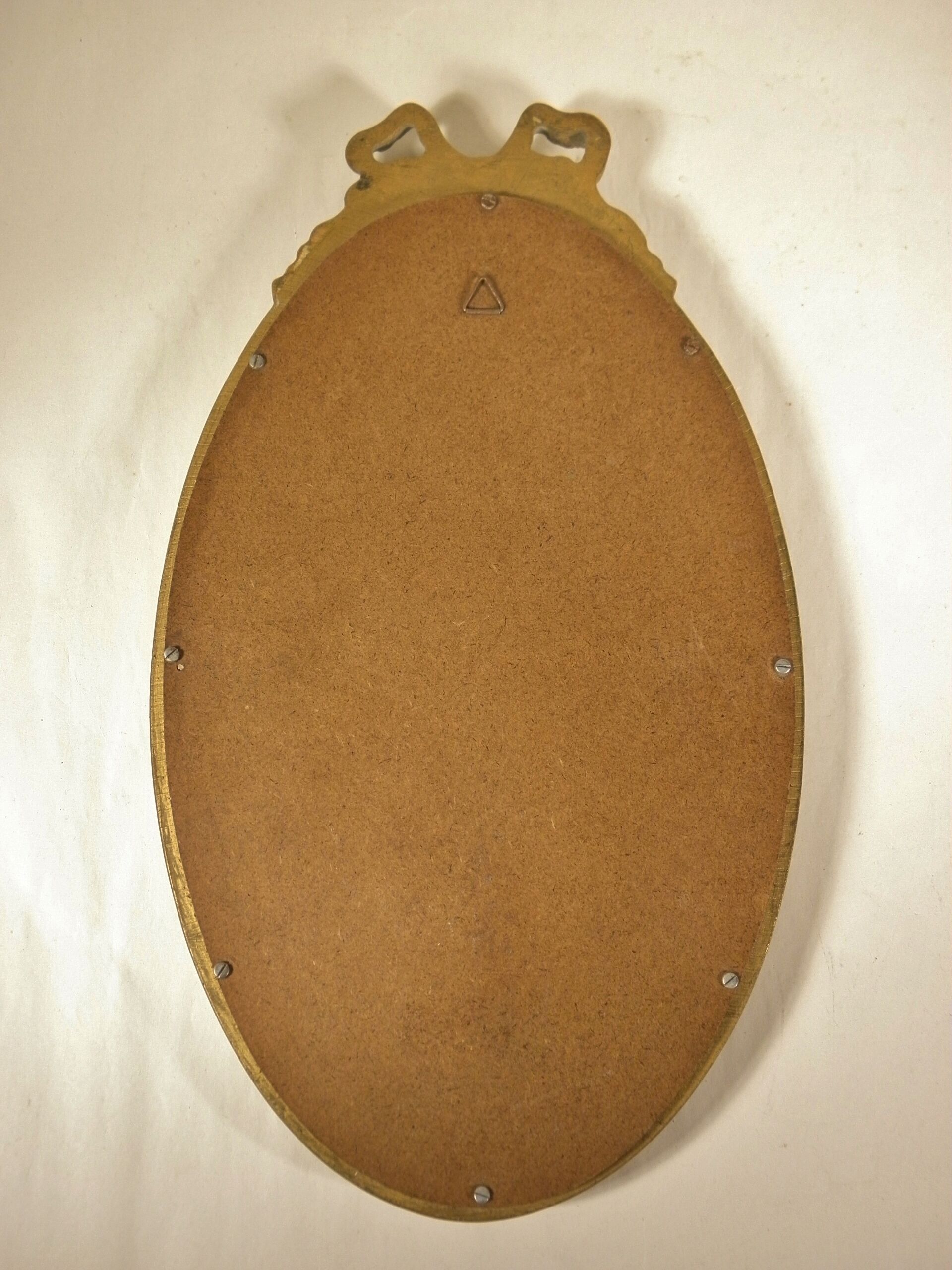 Golden oval mirror