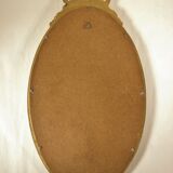 Golden oval mirror
