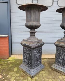 Large antique cast iron vases on pedestal