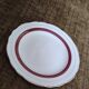 Salins white ceramic dessert plates with red trim and gold rim.