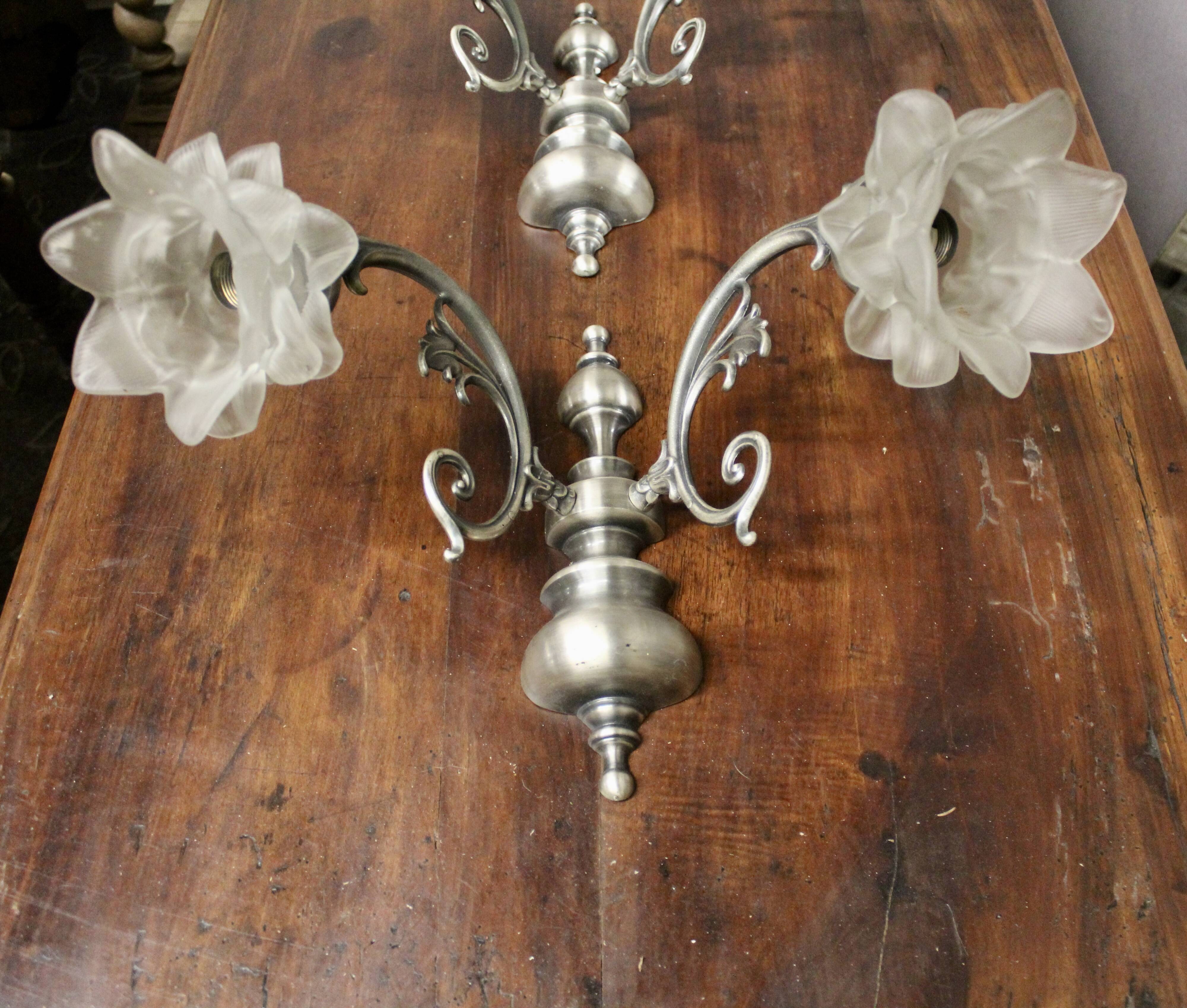 Pair of wall sconces with 2 light arms