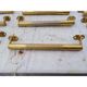 Lot de 12 poignées de portes en laiton art déco