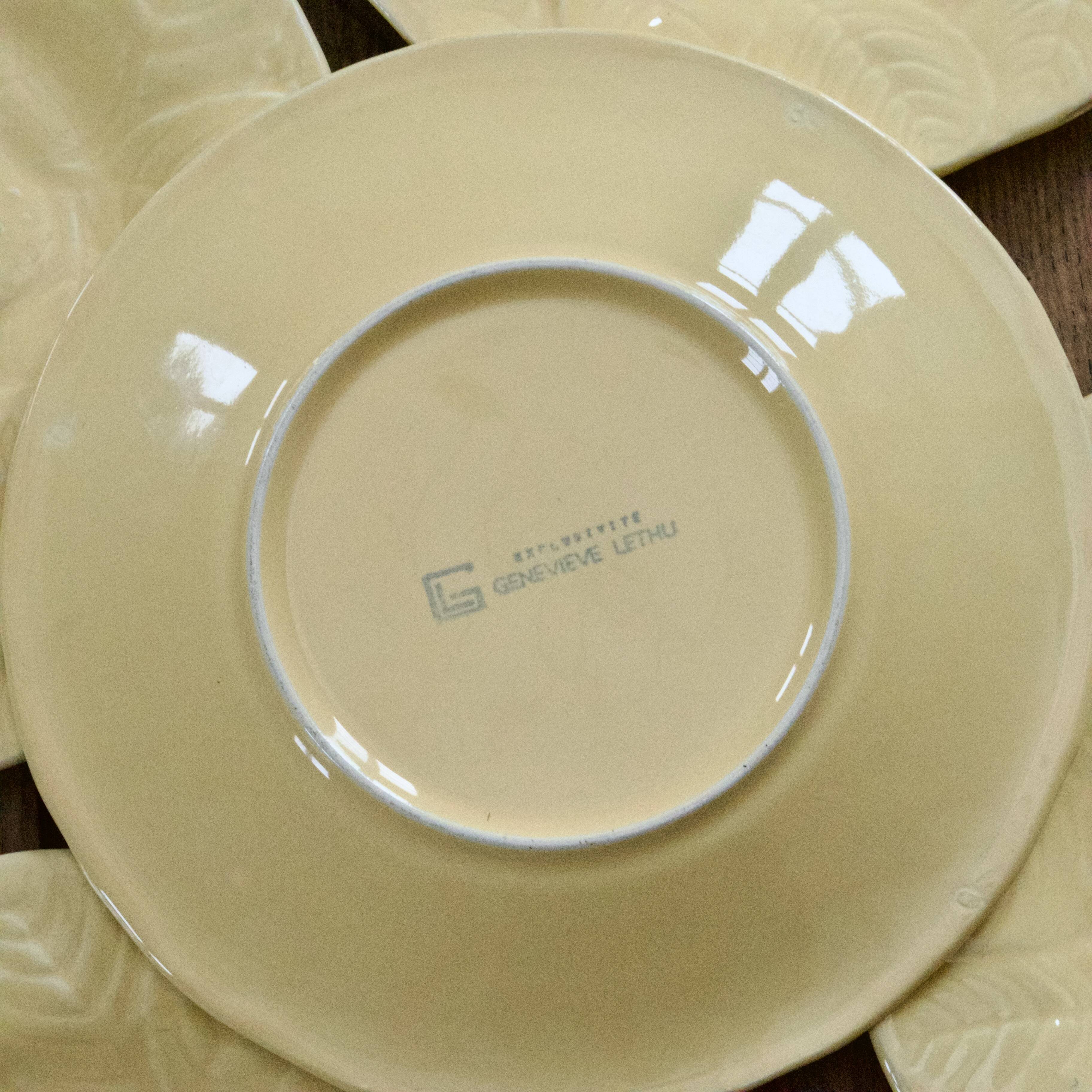 Yellow strawberry slipware plates signed Genevieve Lethu