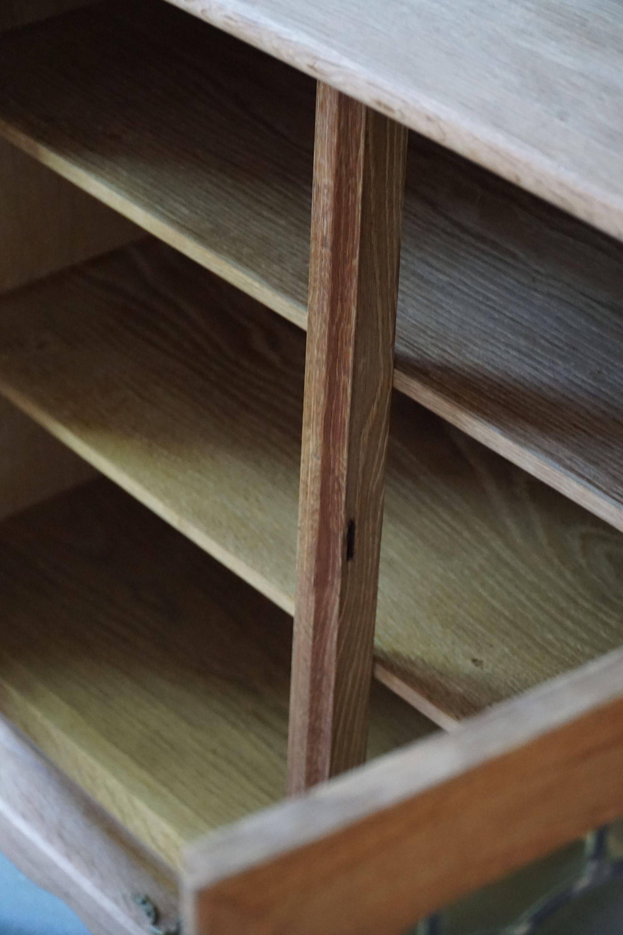 20th-century mid-century solid oak sideboard with glass front, by a Danish cabinetmaker.