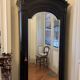 Black wardrobe with a mirrored door in ebony finish.
