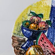 Multicolored hand-painted ceramic wall plate with 1960s Italian fruit motif, signed Stile