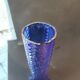 Vintage cobalt blue glass vase with foliage decoration.