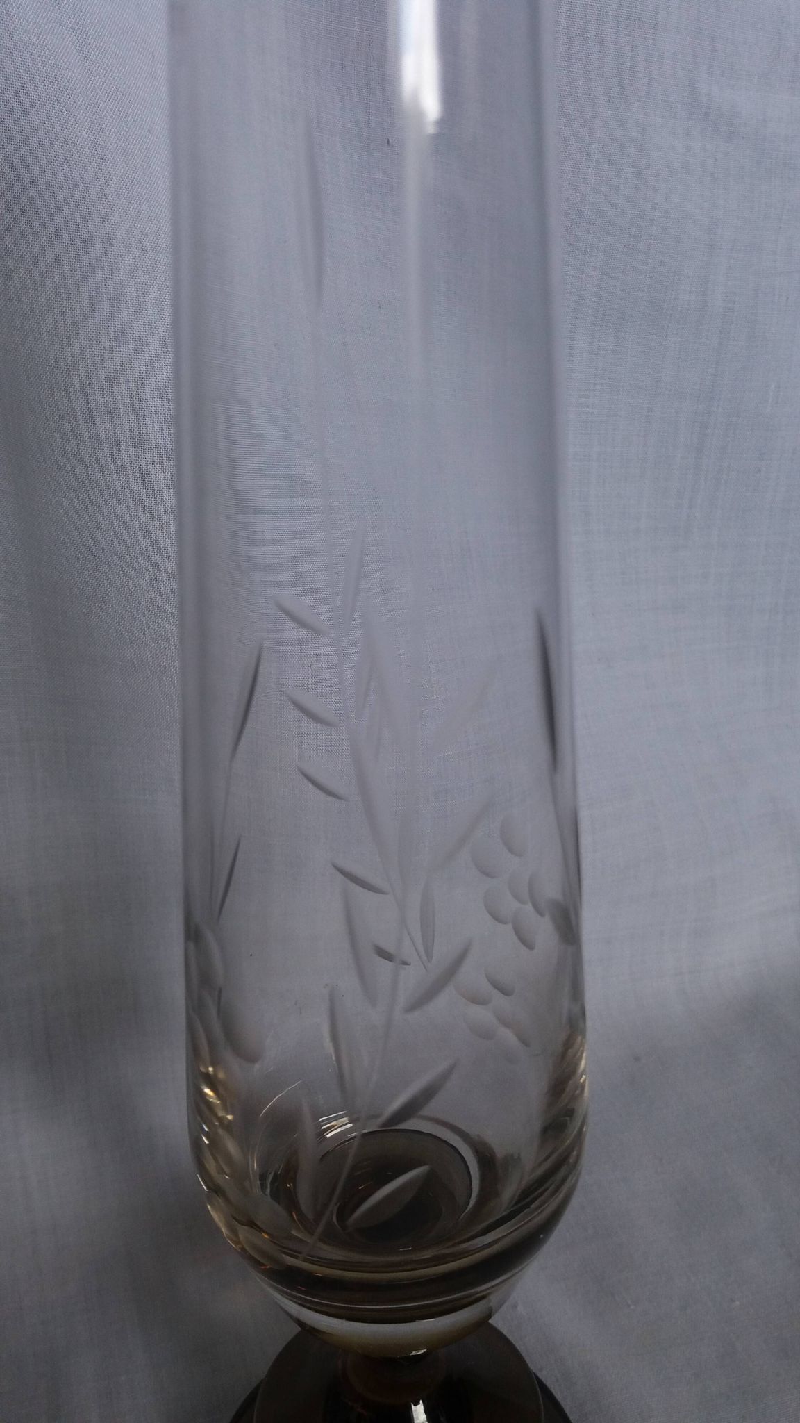 Cut glass soliflore vase with a smoked glass base.