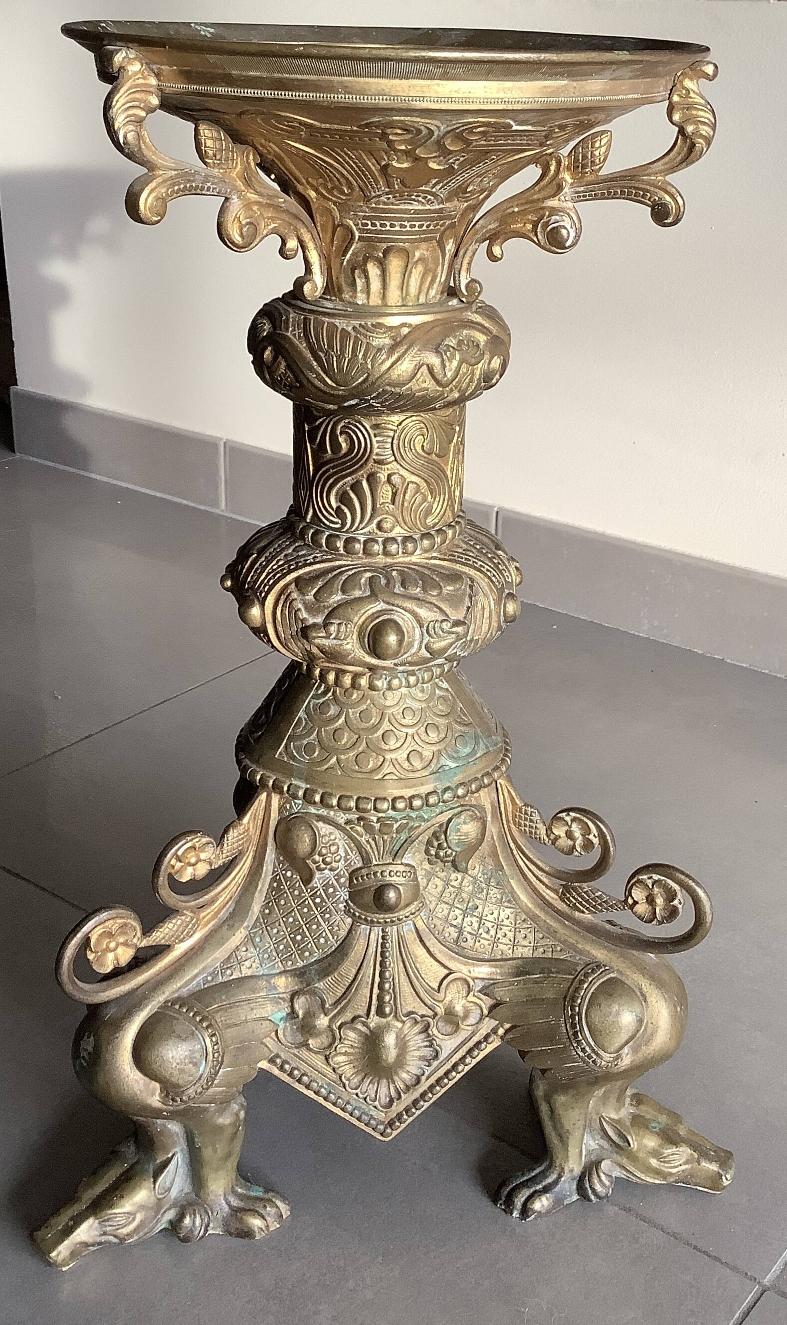 Large bronze candlestick with tripod and winged dog decoration, 19th century.