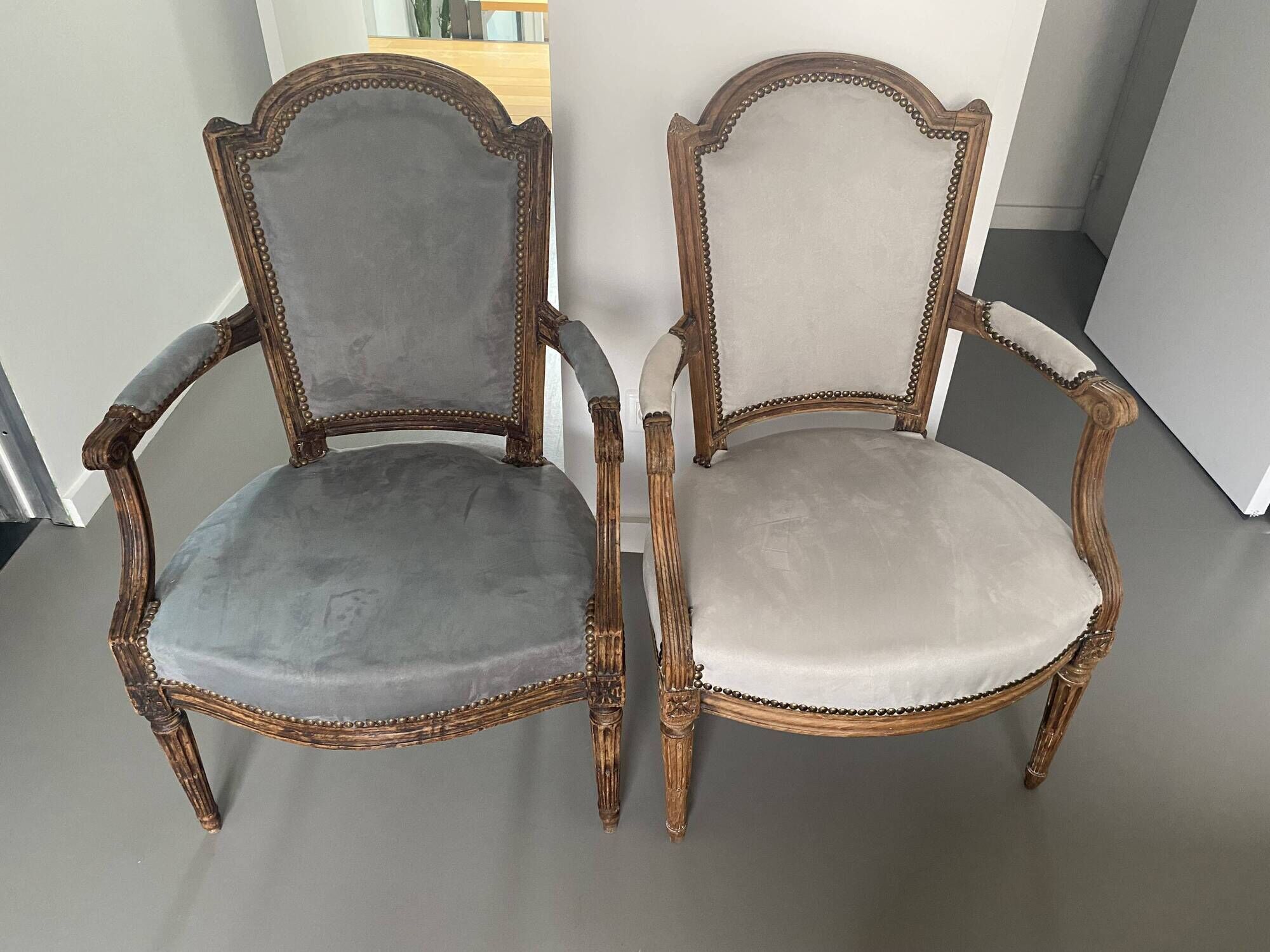 Pair of cabriolet armchairs in light grey and dark grey Louis XV style.