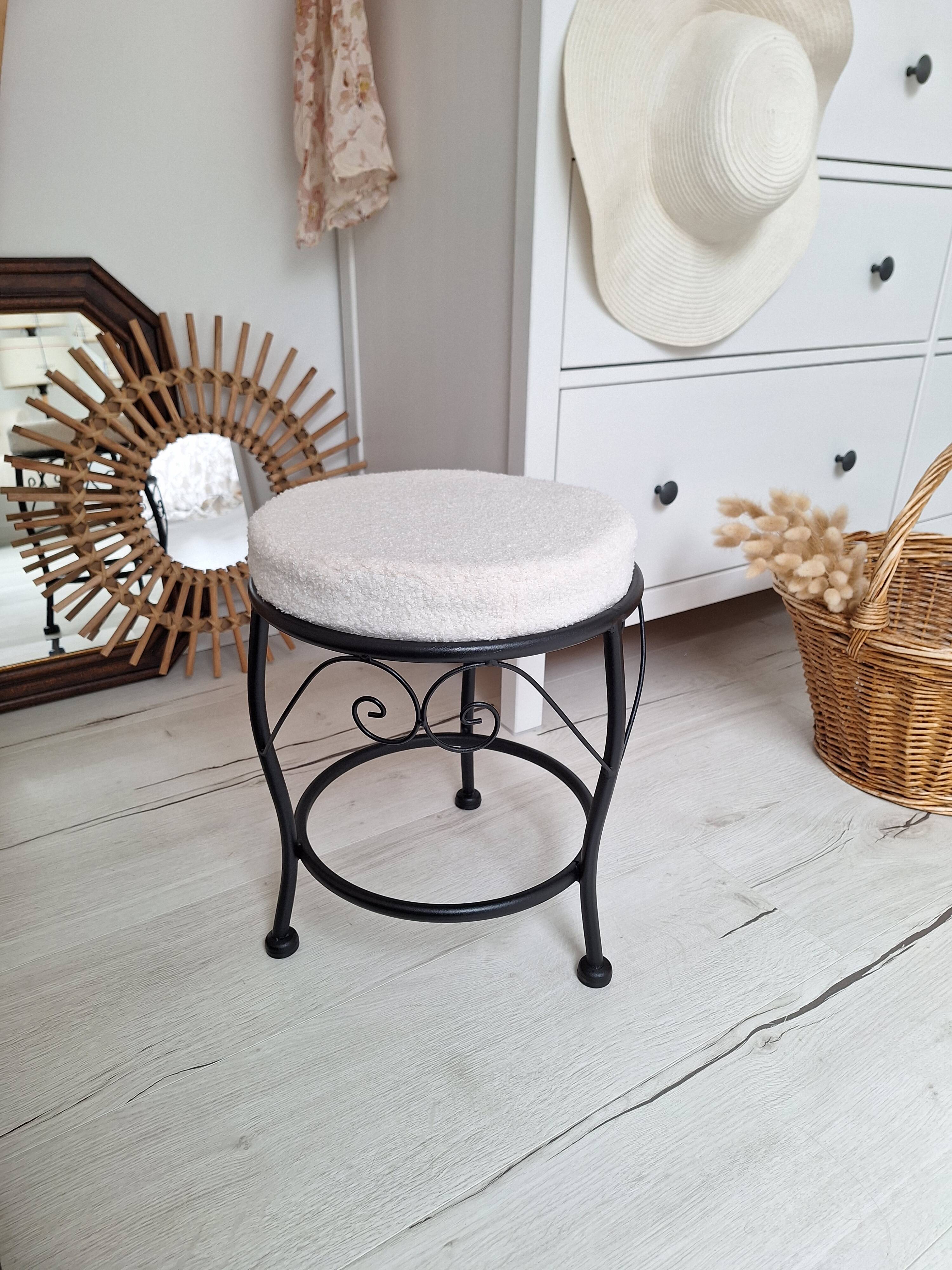 Black iron stool/pouf with its boucle fabric cushion.