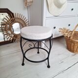 Black iron stool/pouf with its boucle fabric cushion.