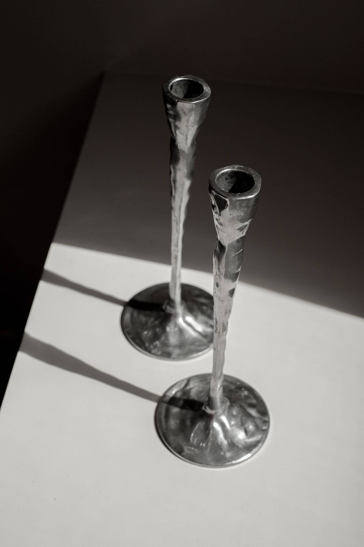 Pair of aluminium candle holders