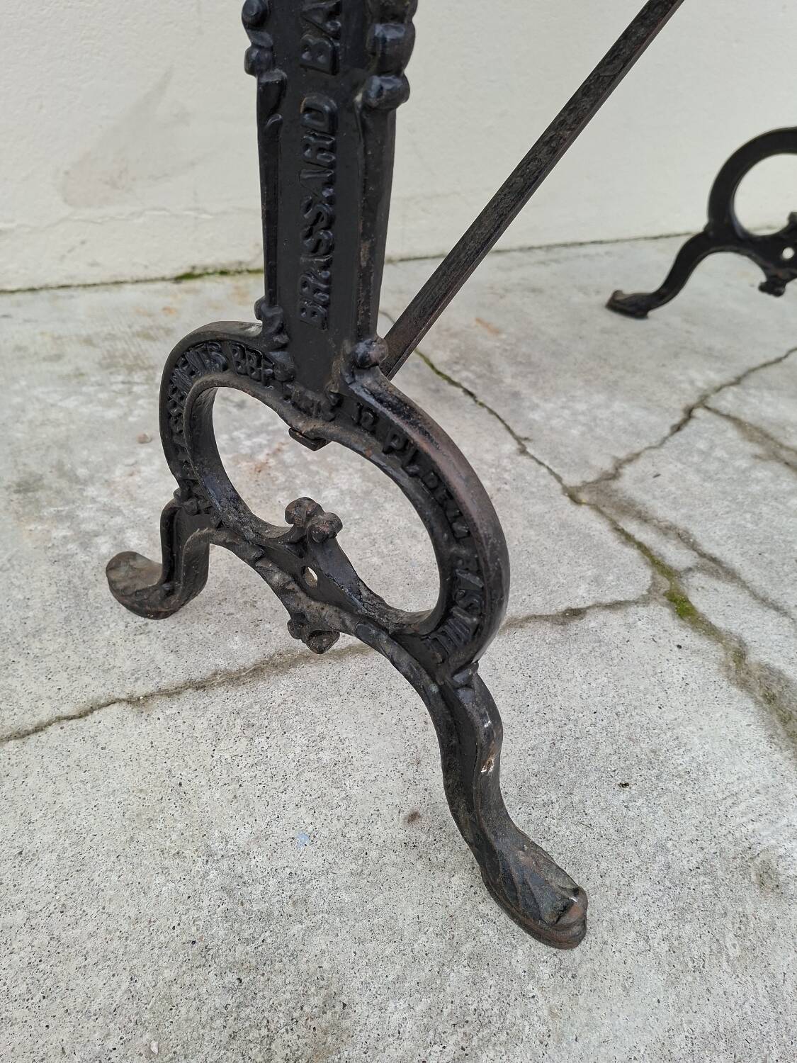 Solid oak bistro table with a cast iron base, signed.