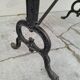 Solid oak bistro table with a cast iron base, signed.