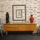 Black-gloved 50s varnished wooden sideboard