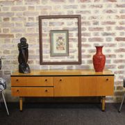 Black-gloved 50s varnished wooden sideboard