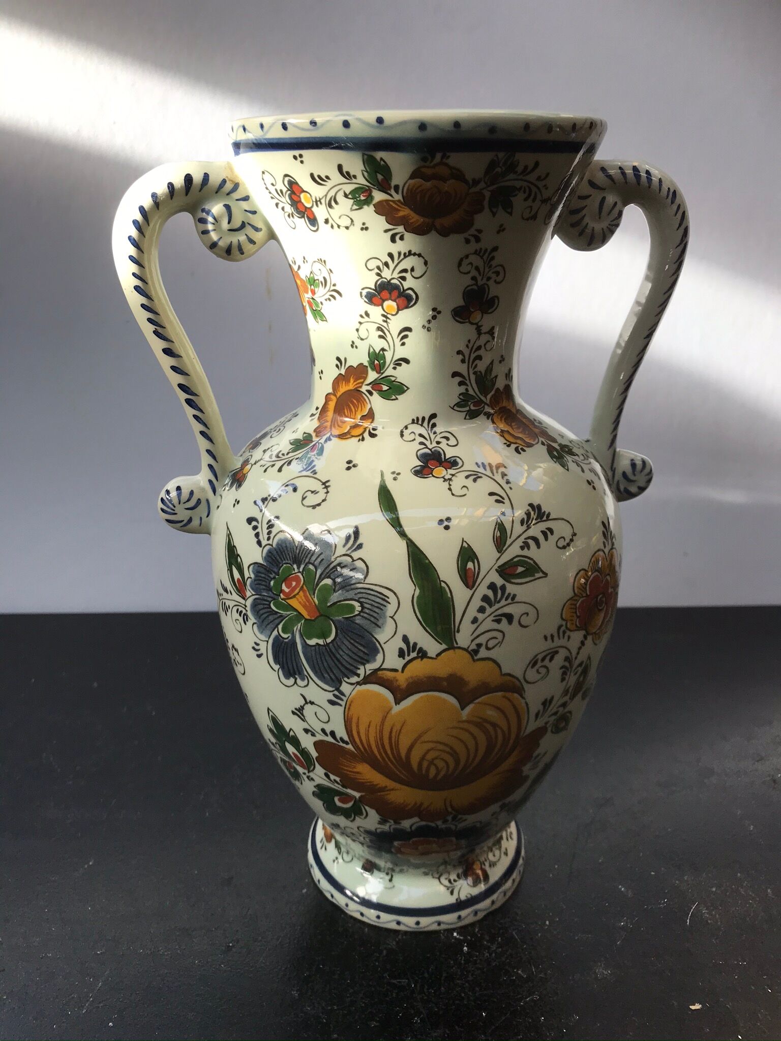 Ancient Delft vase with white ceramics decor vintage flowers