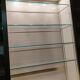 Ivory-colored and matte gold anodized aluminum display bookcase
