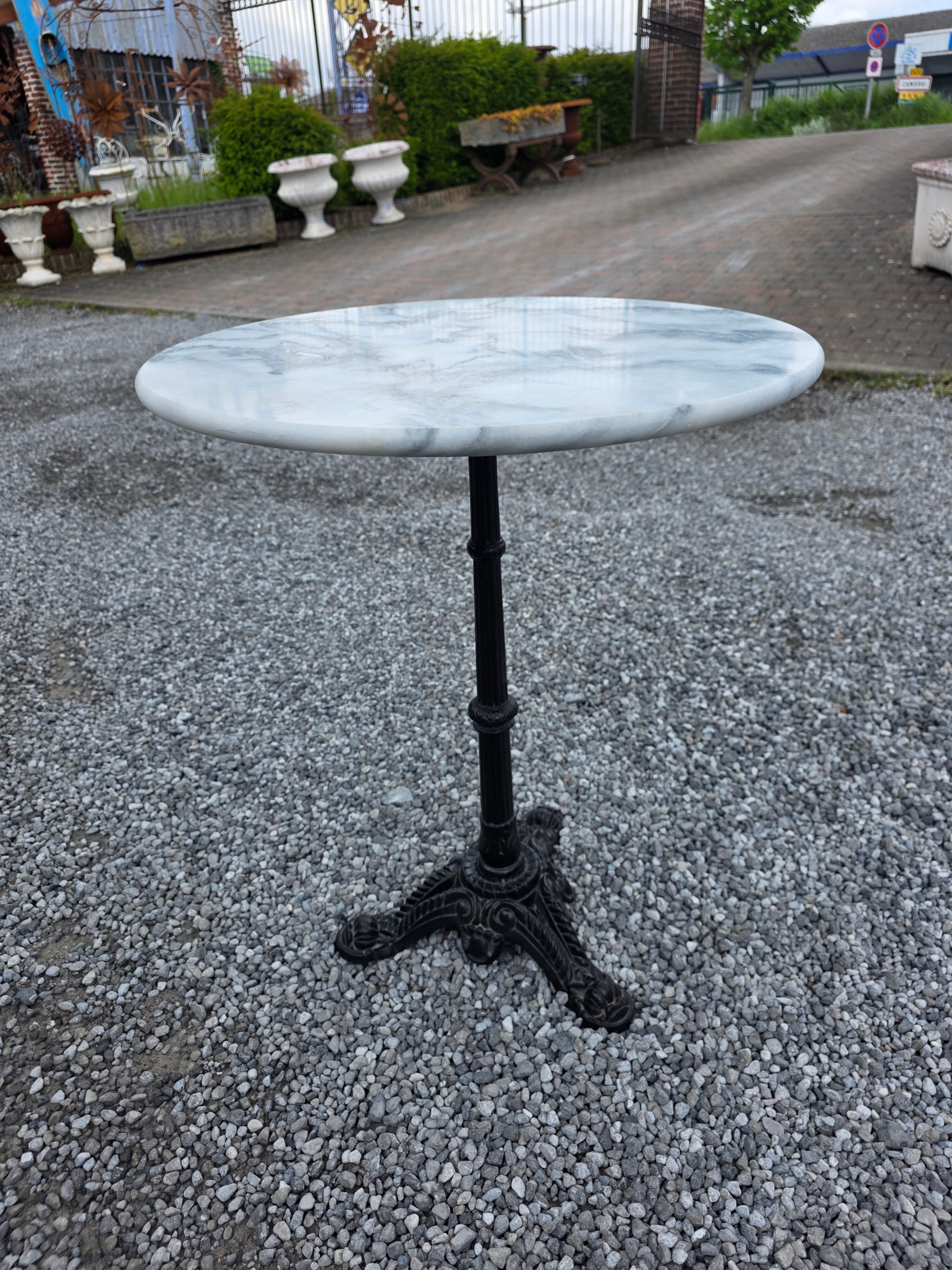 Bistro table with a cast iron base and marble top