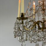 Golden bronze chandelier trimmed with drop-shaped grapevines