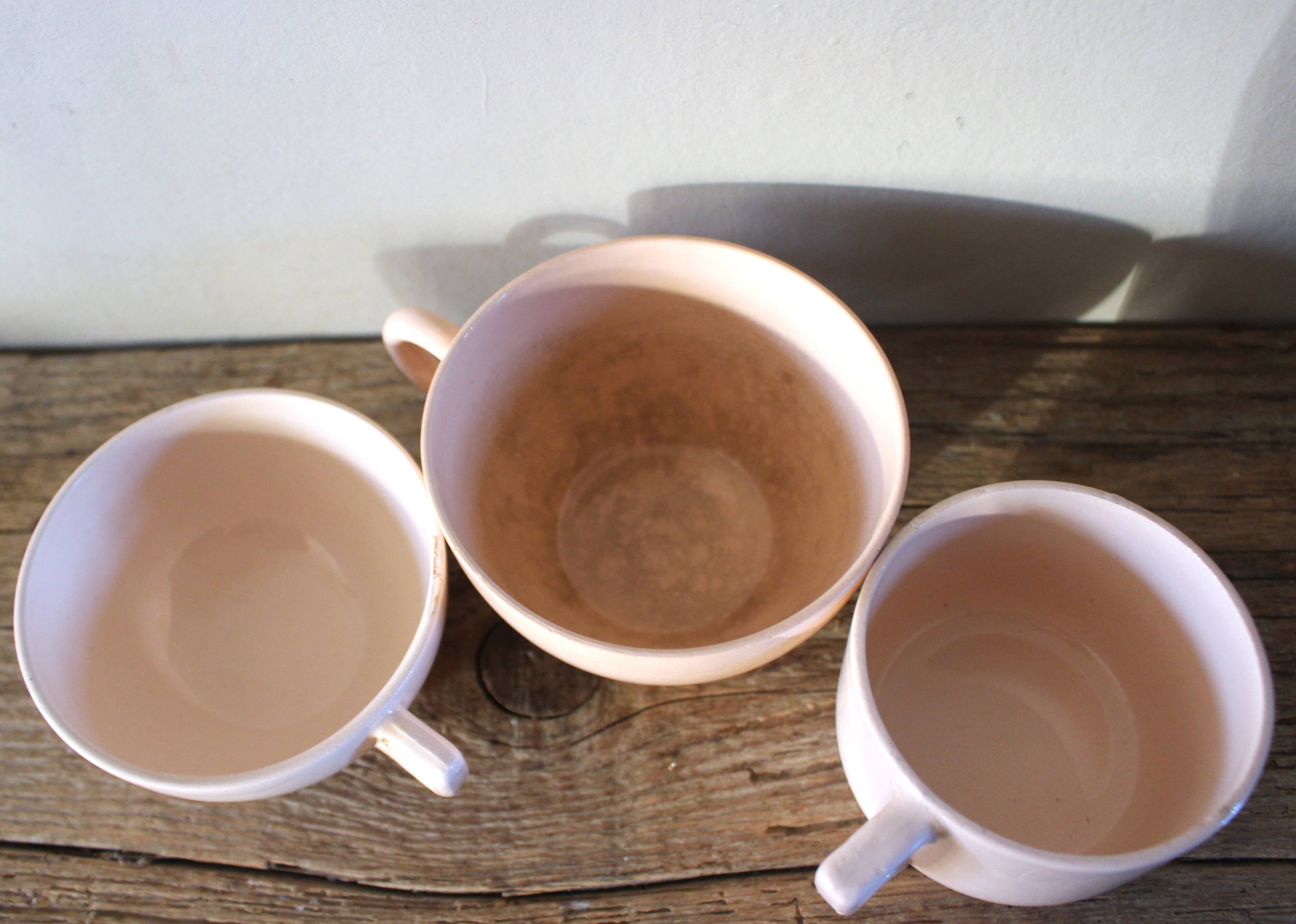 A set of 3 pink earthenware cups from Digoin Sarreguemines.