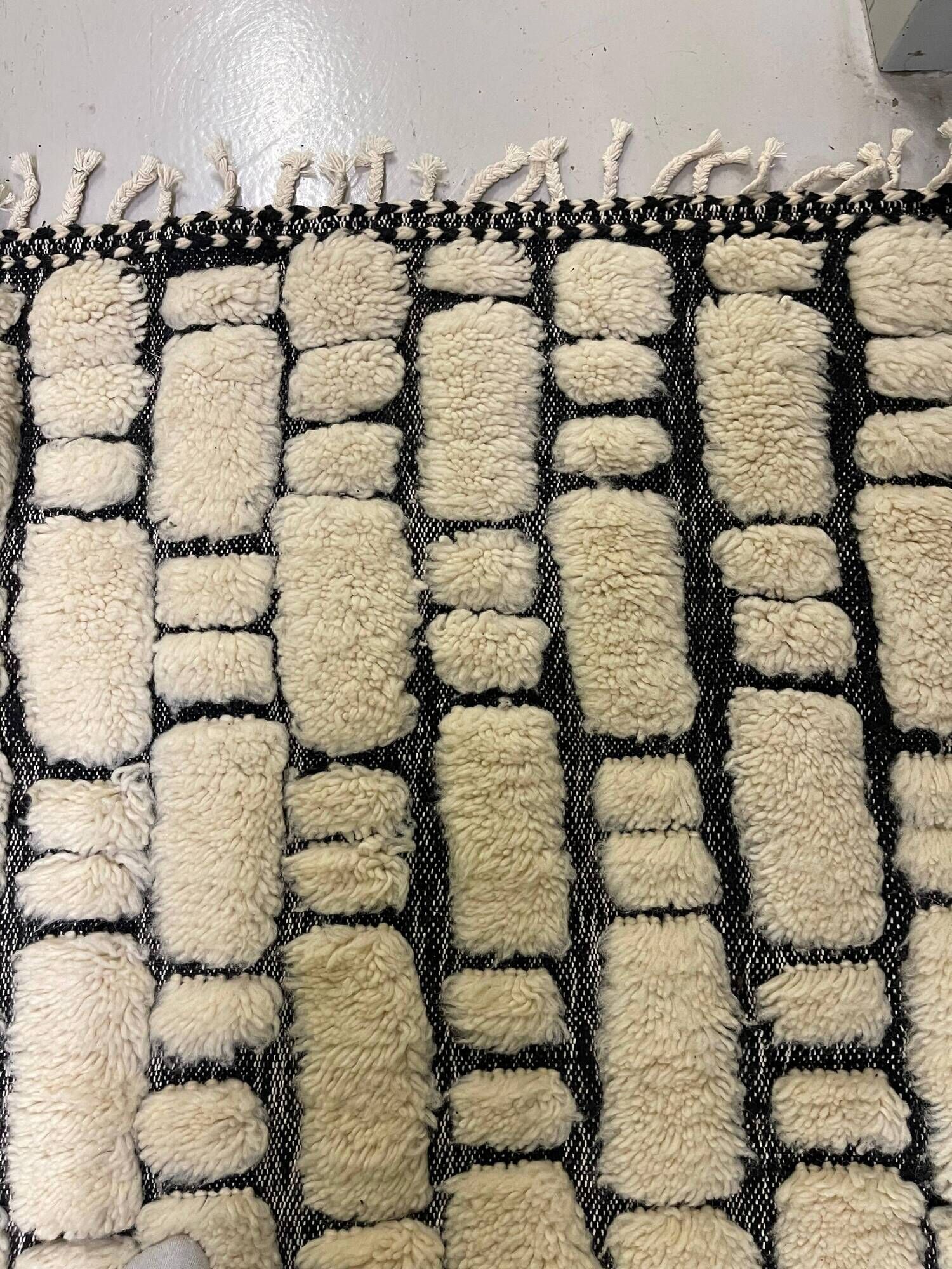 Large cream and black checked Berber rug, 280 × 200 cm.