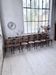 Set of 14 walnut bistro chairs.