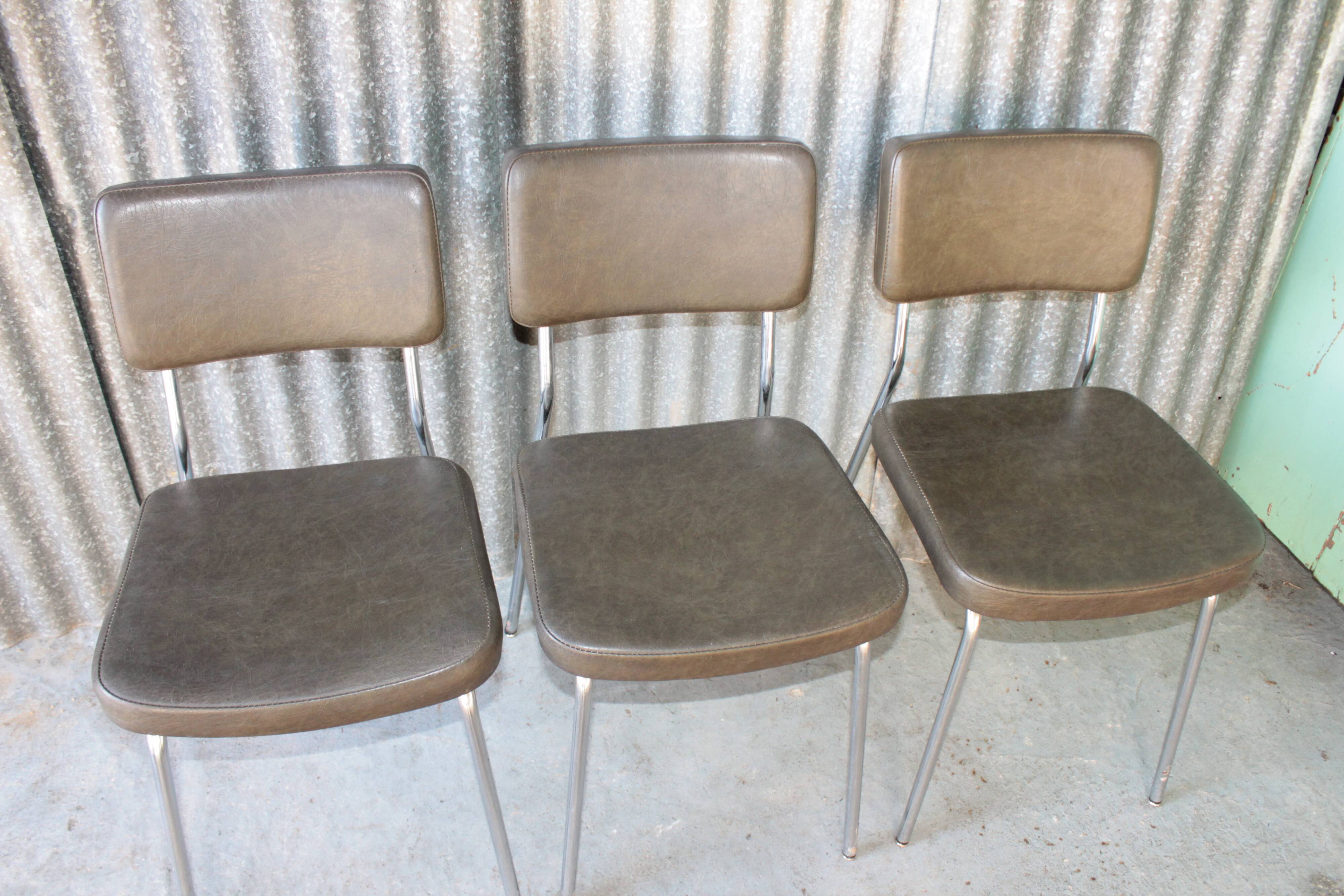 3 bronze-green faux leather chairs with chrome frames