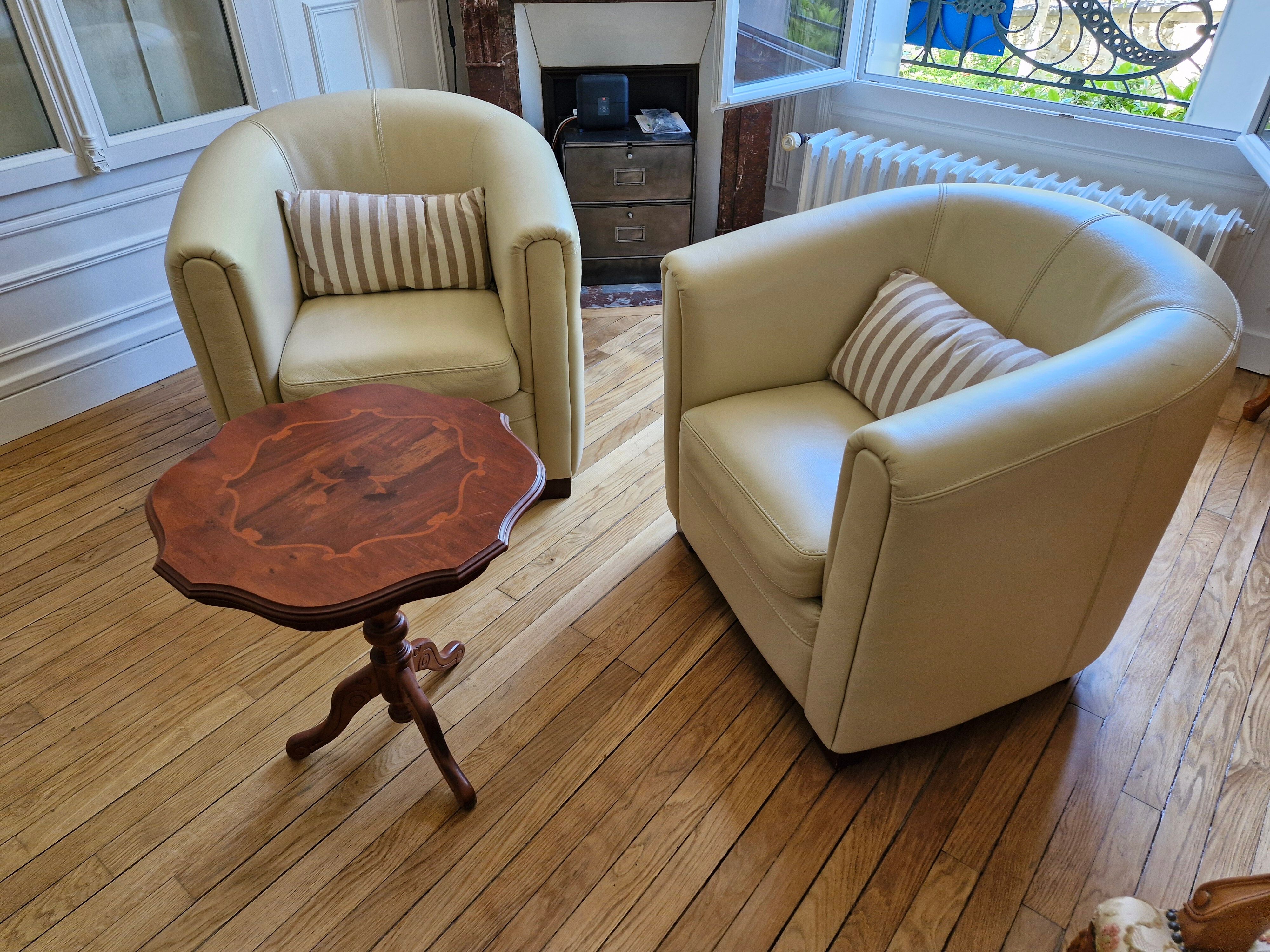 A pair of genuine leather club armchairs.