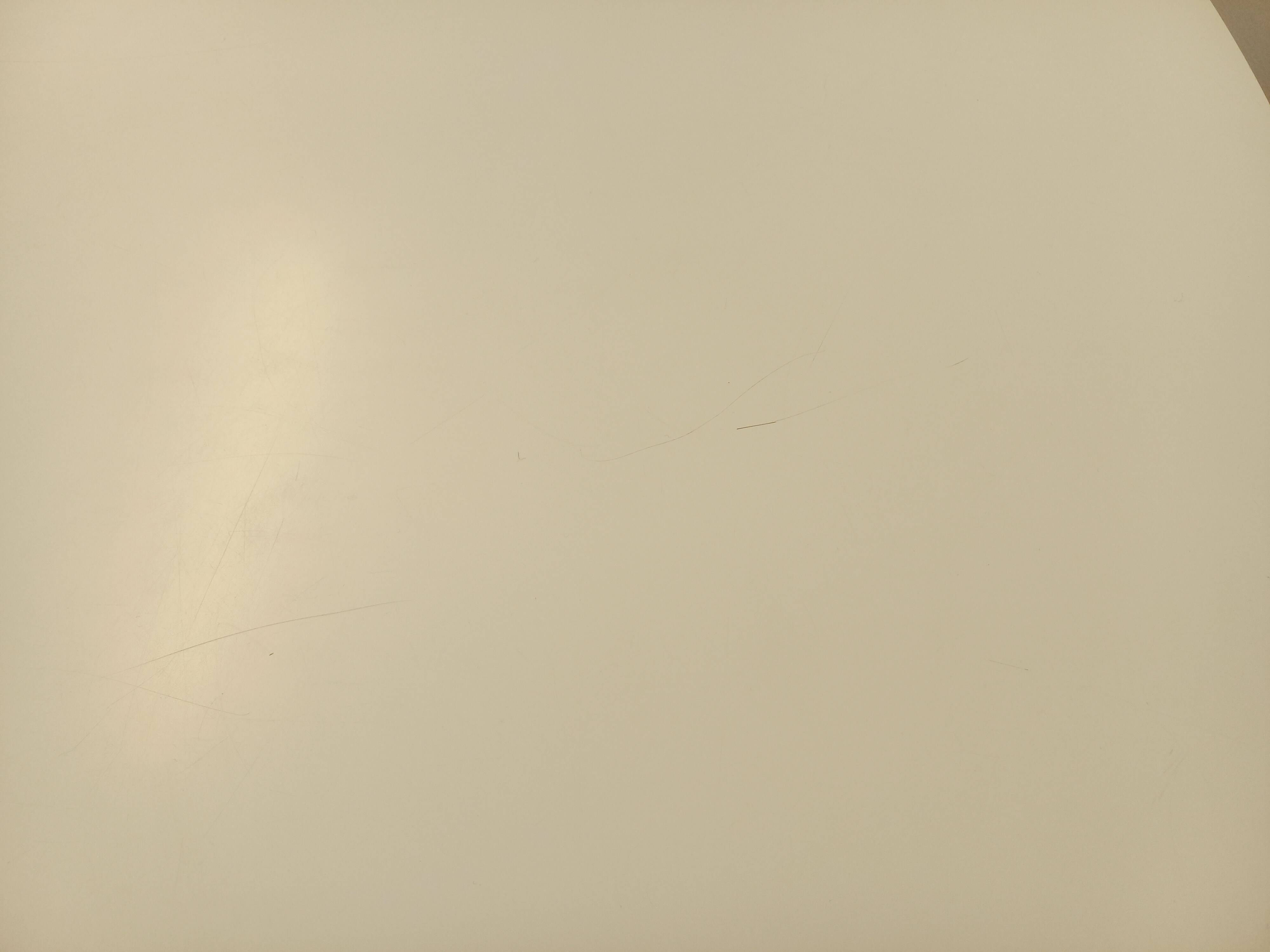 Vintage Eames round table for Vitra in white melamine, wood, and metal.