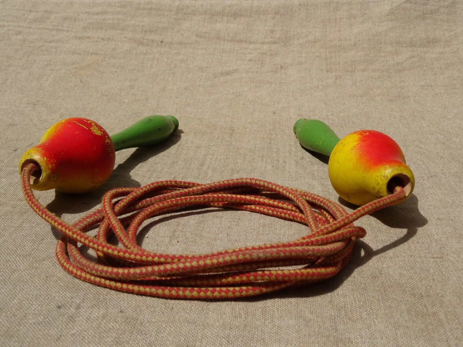 Old wooden jump rope toy painted in the shape of pear fruit ref