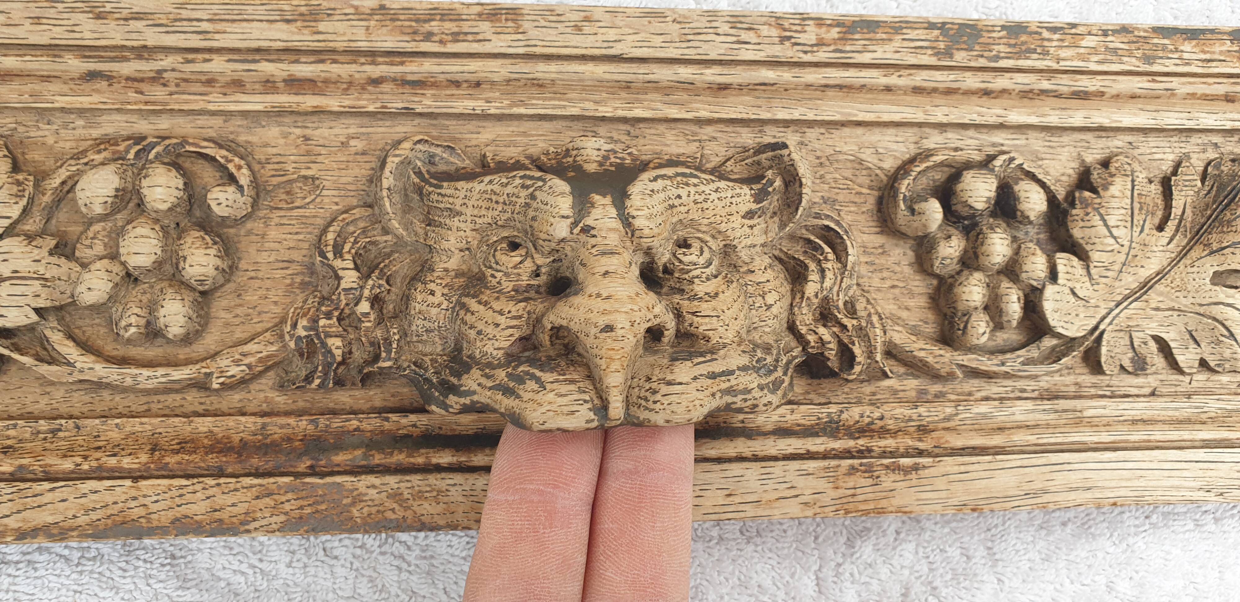 Natural wood pediment with bunches of grapes