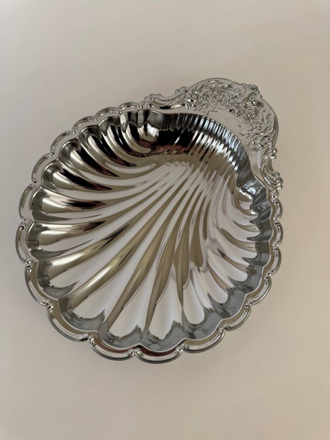 Large silver-plated serving dish in the shape of a vintage shell.