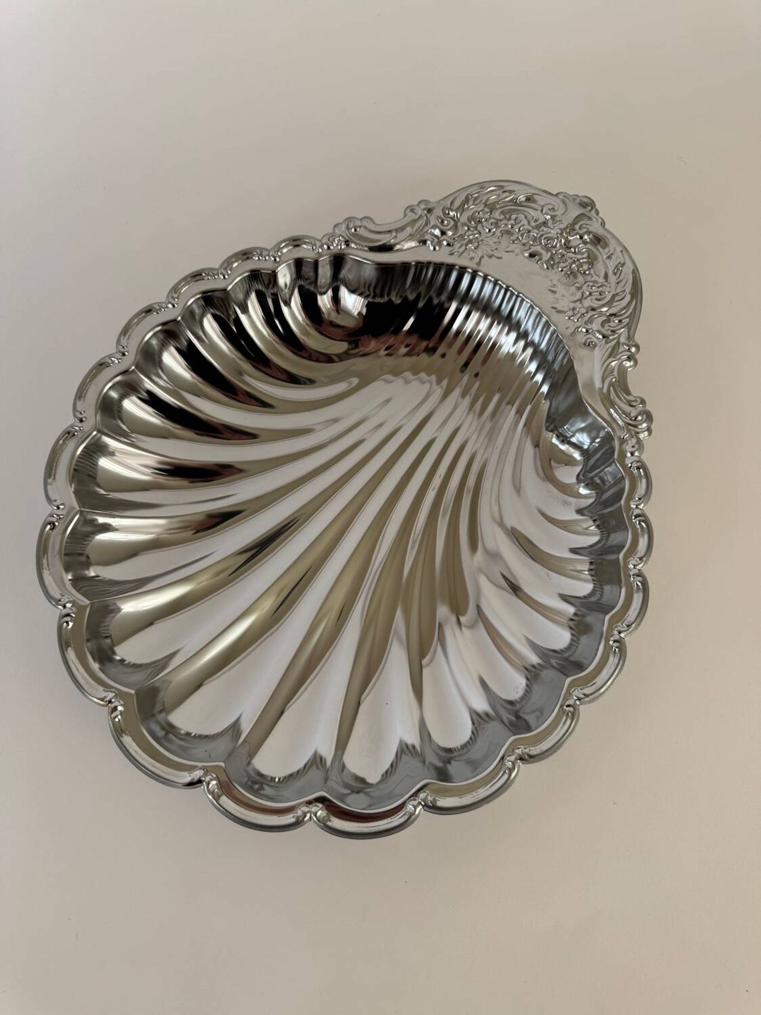 Large silver-plated serving dish in the shape of a vintage shell.