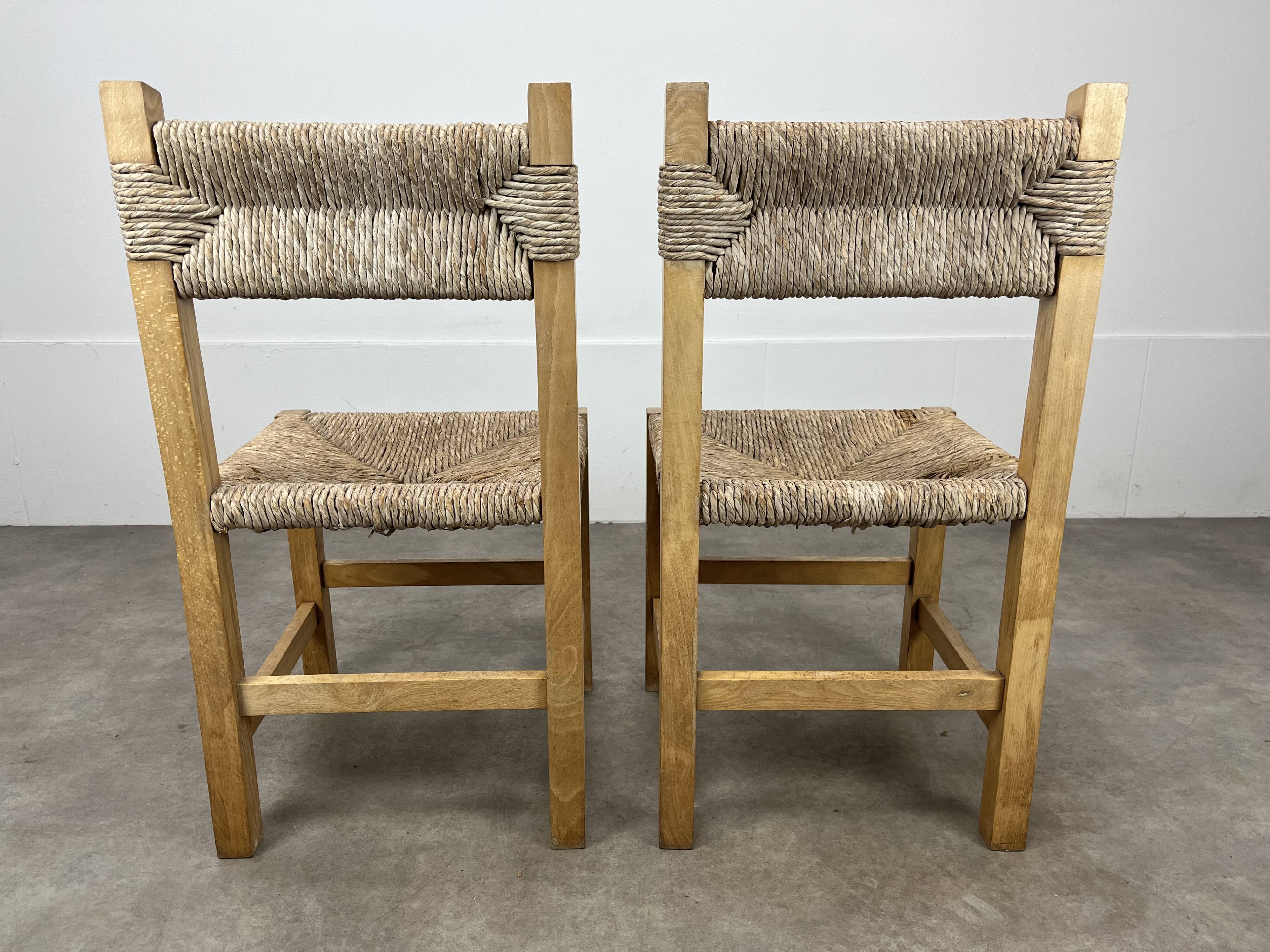 2 straw and wood chairs in brutalist style