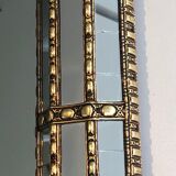 Mirror consisting of multi-faceted mirrors and brass garlands, French work, around 1970