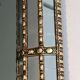 Mirror consisting of multi-faceted mirrors and brass garlands, French work, around 1970