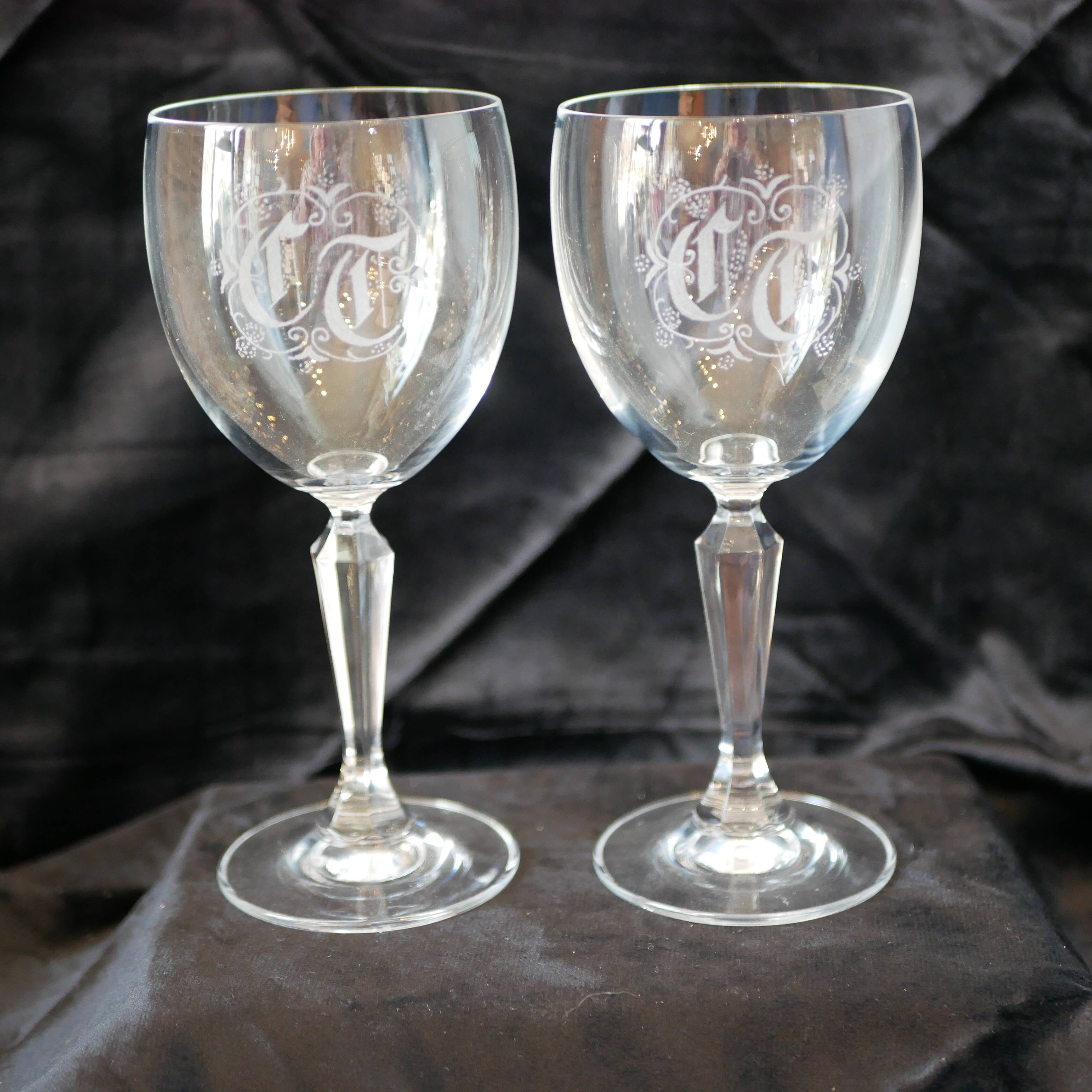 A pair of engraved crystal wine glasses