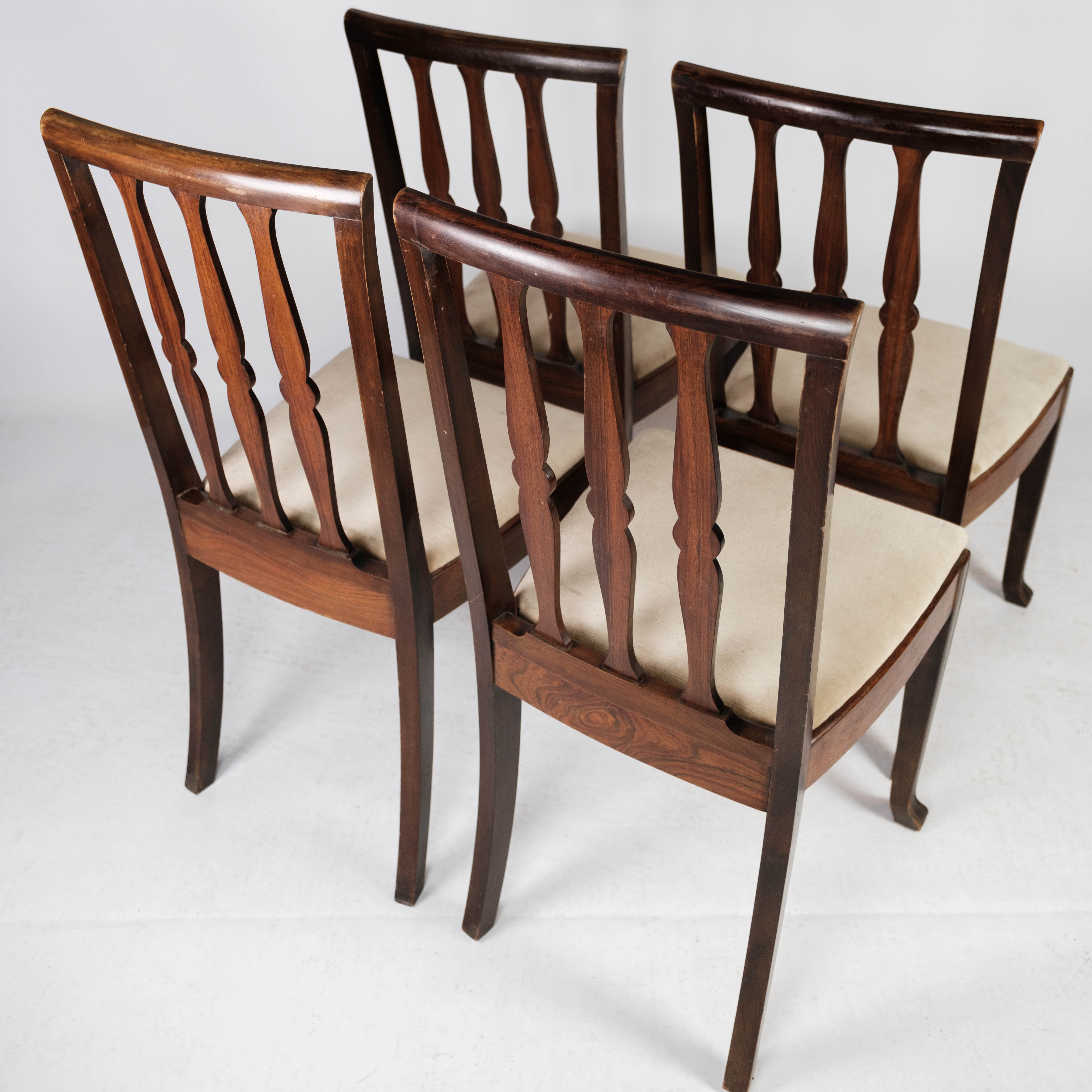 Set of four dining room chairs in rosewood and upholstered with light fabric, 1920s