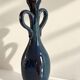 Decorative deep blue glazed ceramic vase with twin handles.