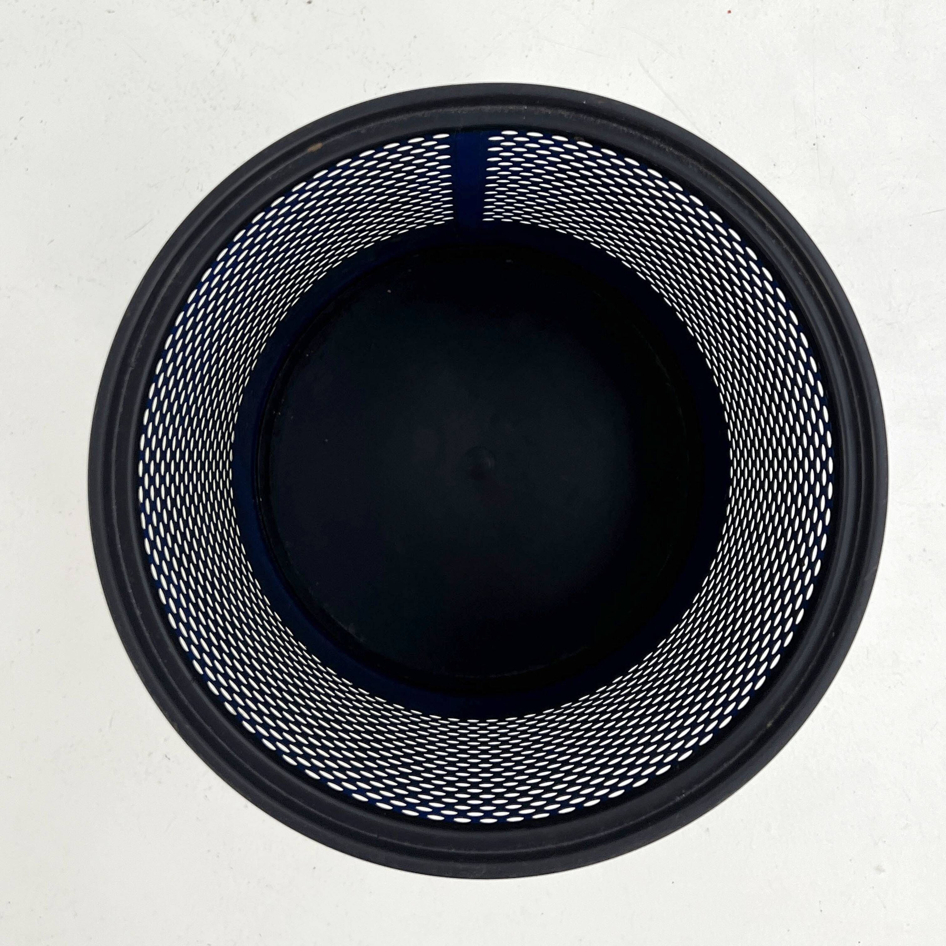 Blue perforated metal bin, 1980