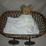 Cradle of doll in rattan on wheels